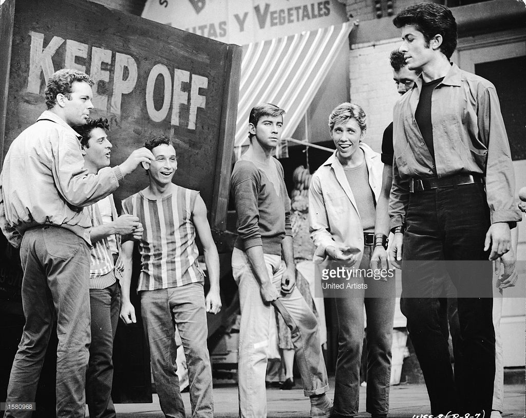 Getty image of black and white scene from 1961 West Side Story, Jets group singing the song Cool.